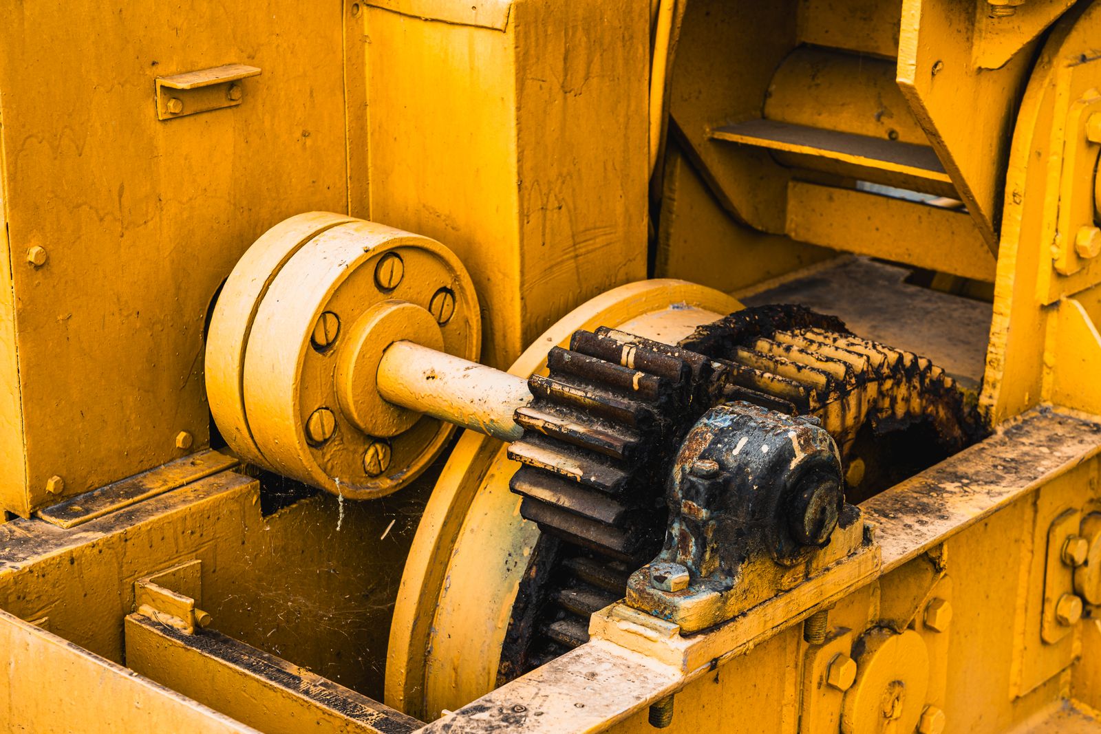 Yellow painted industrial metal gears and drive components